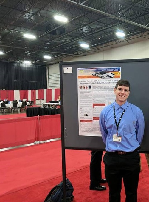 Michael Snowdon standing in front of his SPE ACCE poster.