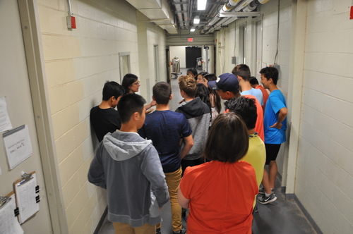 Sue Couling leading a group of high school students through the Growth Facilities