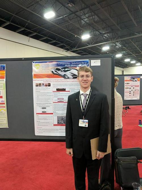 Christoff Reimer standing in front of his poster at SPE ACCE.